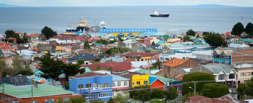 Scenic view of Punta Arenas - colourful houses and a boat in the background