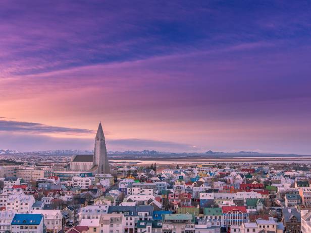 Colourful houses of Reykjavik against a backdrop of snowy mountains