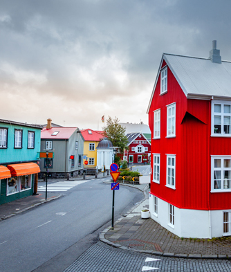 a street in Iceland with a bright red house in the centre