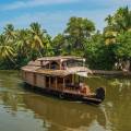 Wooden boat drifting along the river in Kumarakom