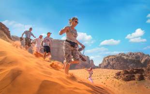 Running down dunes in Wadi Rum - Jordan tours - On the go Tours
