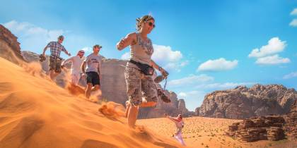 Running down dunes in Wadi Rum - Jordan tours - On the go Tours