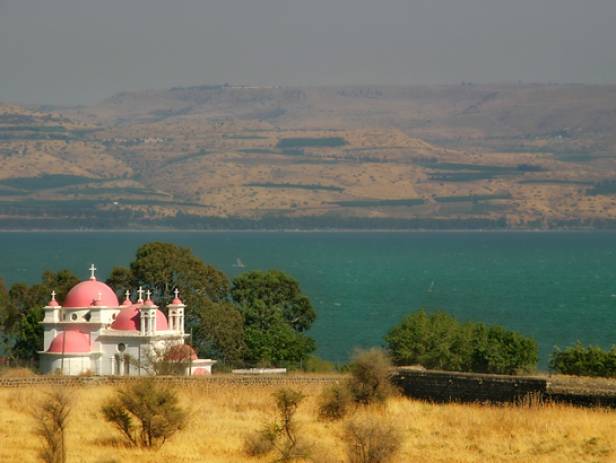 Dazzling blue water of Sea of Galilee running along the edgy of the Jewish Holy City of Tiberias