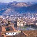 Looking out across the rooftops around the Plaza de Armas in Cuzco with the Andean mountains in the 