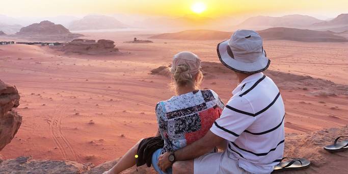 A couple watching the sunset in Wadi Rum desert | Jordan
