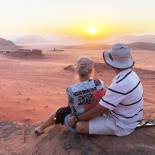 A couple watching the sunset in Wadi Rum desert | Jordan