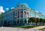 The vivid blue and white exterior of the Sevastyanov merchant house in Yekaterinburg