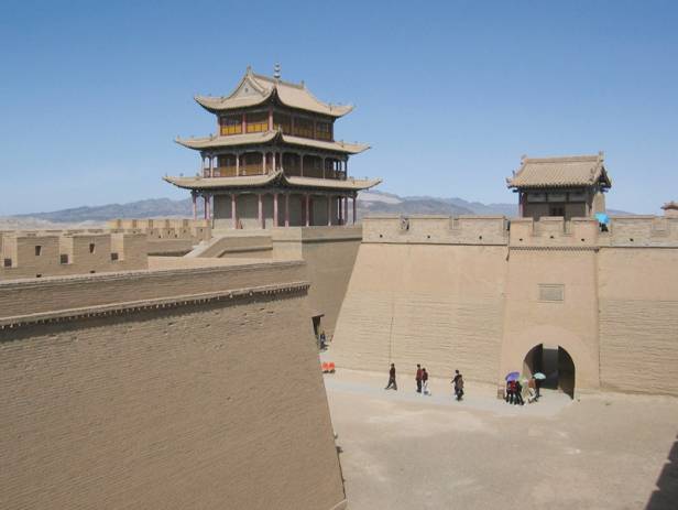 A temple standing majestically next to a lake in Jiayuguan