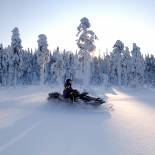 Snowmobiling by the forest | Finland