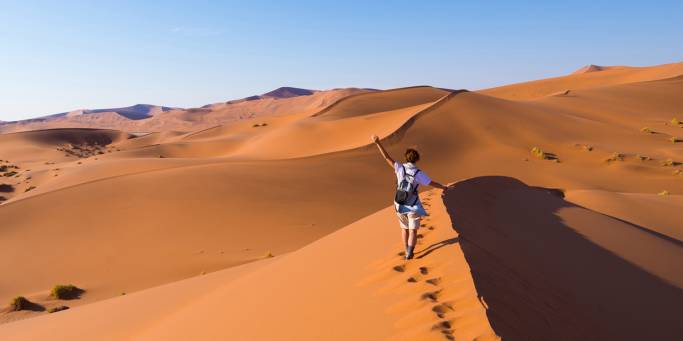 Solo female traveller hiking in the Namibian sand dunes | Namibia