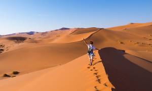 Solo female traveller on Namibian sand dunes - On The Go Tours