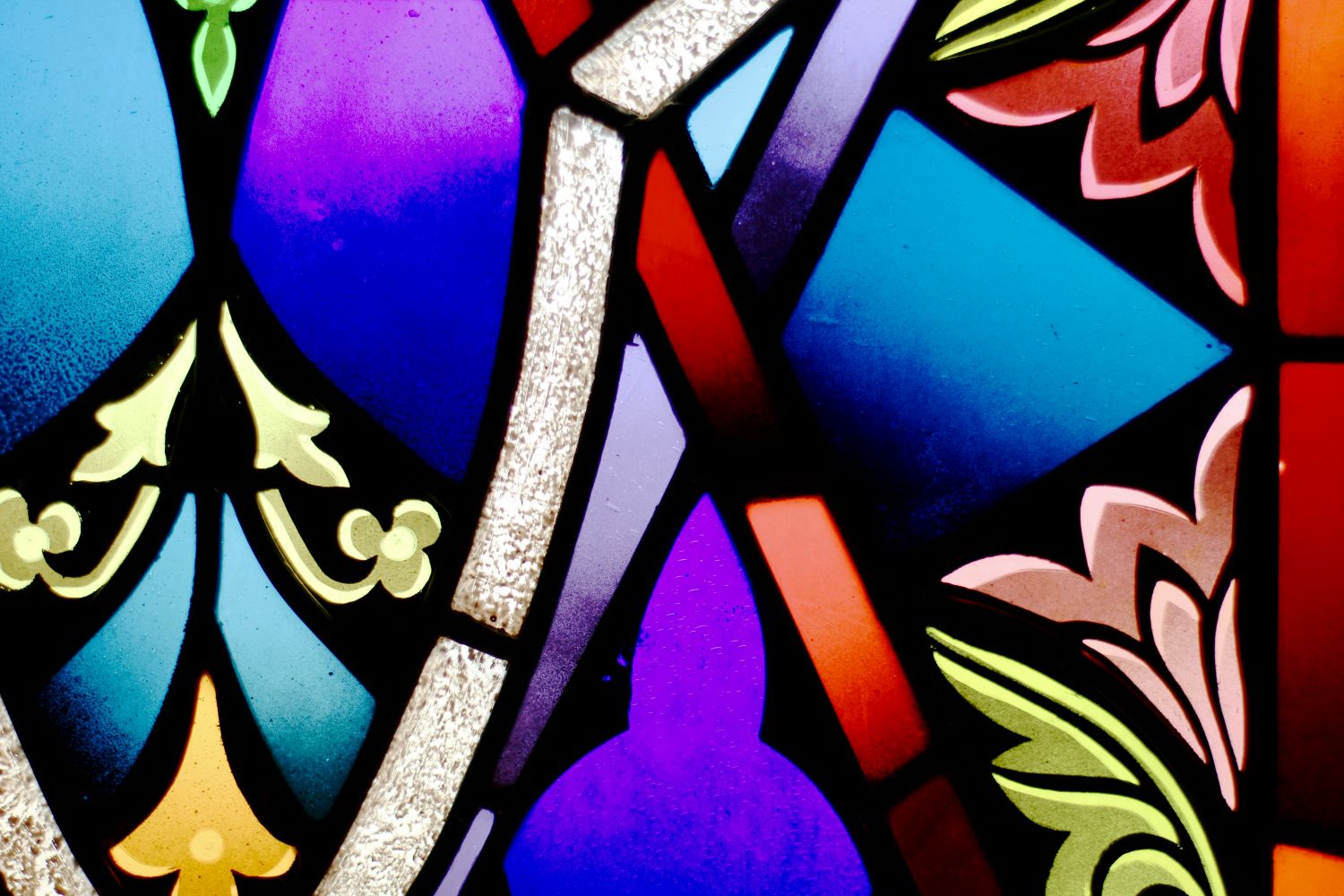 a close up of vibrant coluored stained glass