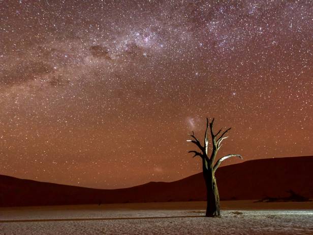 Orange sand dunes and rocky mountains at Namib Naukluft National Park