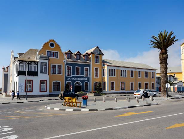 Colonial building and palm trees at dusk in Swakopmund