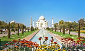 Taj Mahal with colourful flowers in foreground - India Tours - On The Go Tours
