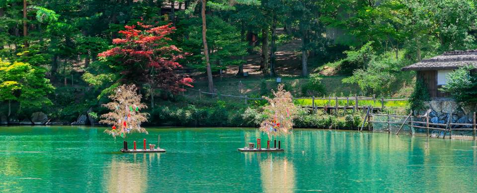 Beautiful, turquoise water surrounded by lush forest in Takayama