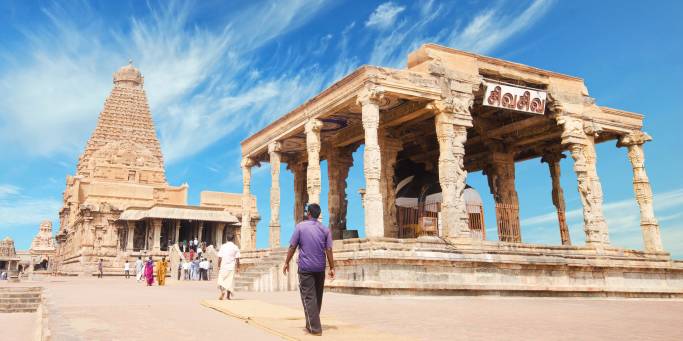 Brahadishwara Temple in Tanjore against a dazzling blue sky with wisps of cloud