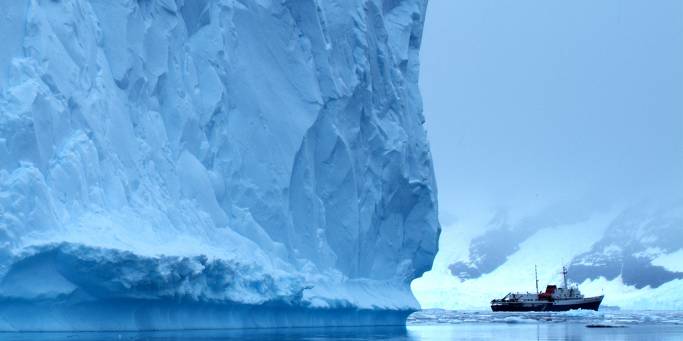 The Ushuaia with a giant iceberg | Photo courtesy of Weisheng Lin | Antarctica