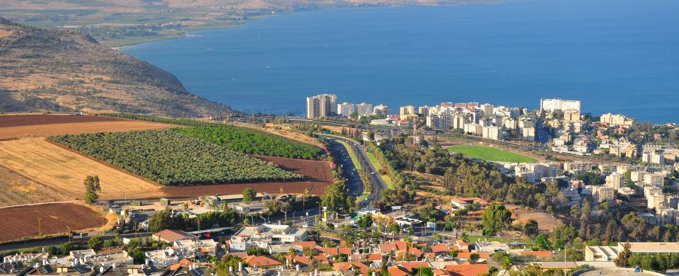 Dazzling blue water of Sea of Galilee running along the edgy of the Jewish Holy City of Tiberias