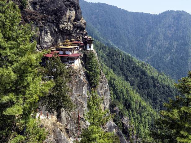The Tiger Nest temple sitting precariously on the side of a cliff in Paro