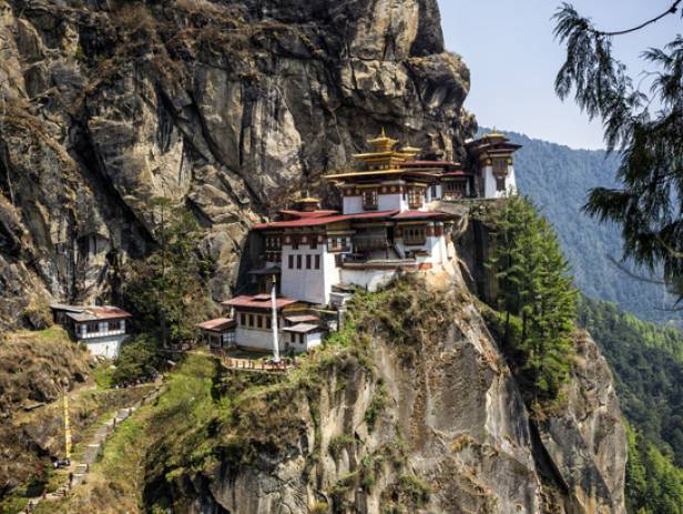 The Tiger Nest temple sitting precariously on the side of a cliff in Paro
