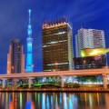 Rainbow Bridge, stretching across the water in Tokyo, lit up at night