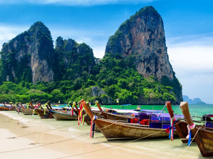 Traditional thai boats at a beach in the Krabi province
