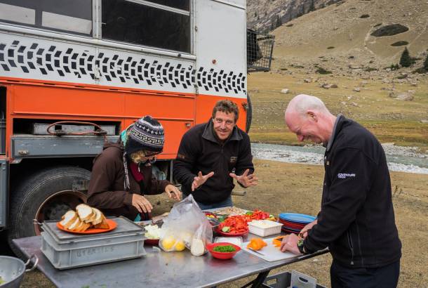 Travellers preparing food together on overland tour, South America