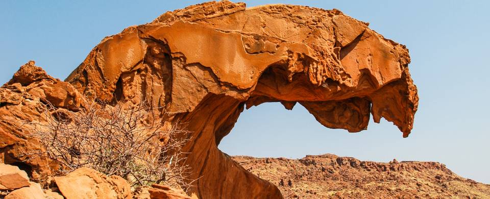 Curved rock against a bright blue sky at Twyfelfontein