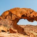 Curved rock against a bright blue sky at Twyfelfontein