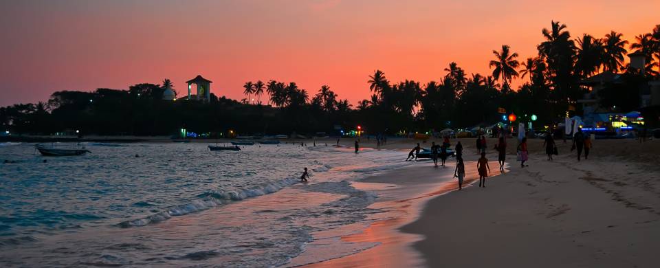 Sunset painting the sky pink and orange on the beach in Unawatuna