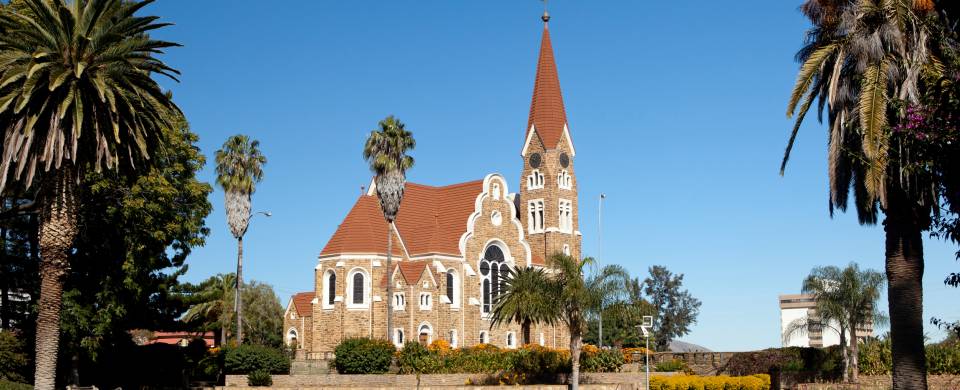 Church in Windhoek with palm trees and bright blue sky