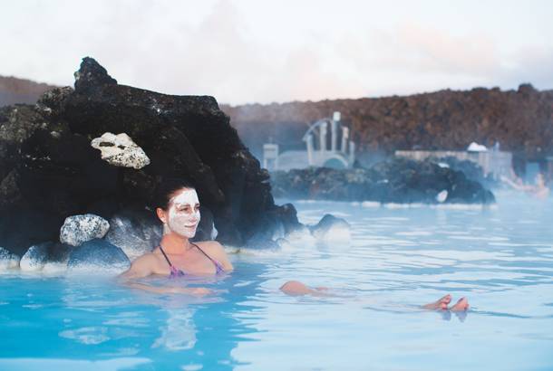 Woman soaking in Blue Lagoon - Travel Tips