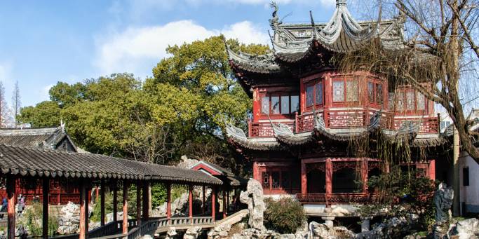 A traditional wooden pavilion and walkway in the attractive Yu Yuan Gardens in Shanghai