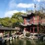 A traditional wooden pavilion and walkway in the attractive Yu Yuan Gardens in Shanghai