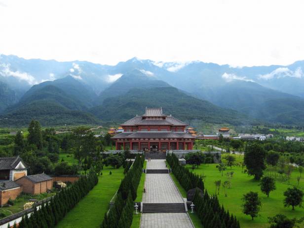 A temple of the waterfront, surrounded by lush foliage, in Dali