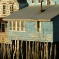 View of houses on stilts along the waterfront of Chile