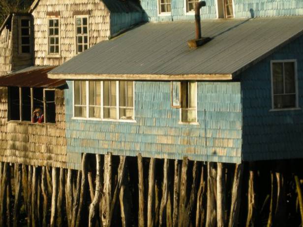 View of houses on stilts along the waterfront of Chile